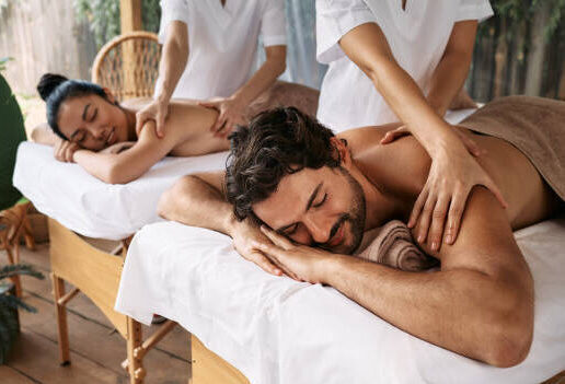 Couple massage at spa resort. Beautiful couple getting a back massage outdoor, romantic weekend and relax